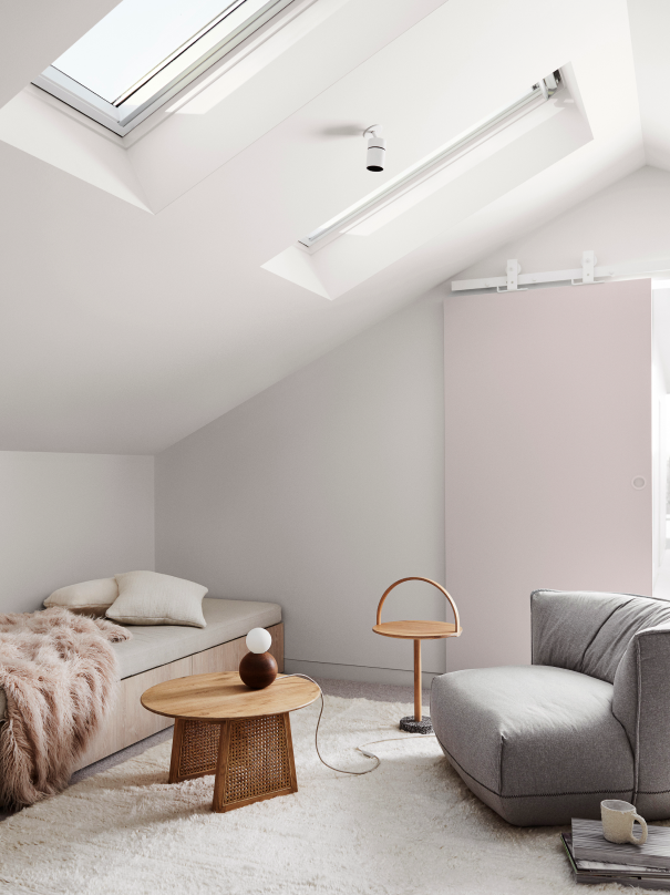 Modern attic with skylights interior, resting nook in neutrals, bench seat, wooden side tables, grey armchair and sliding door