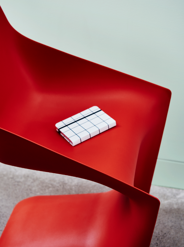 Dulux Carnelian is a soft feature against a striking red chair.
