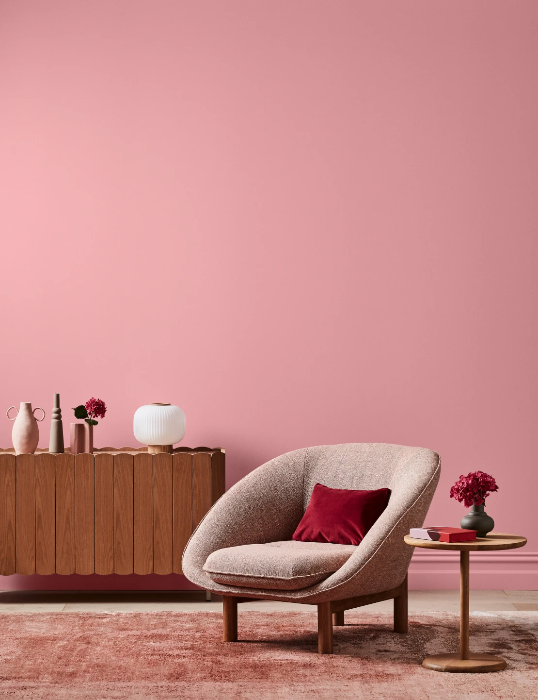 Living room with Perfect Pink coloured wall timber furnishings and neutral seat