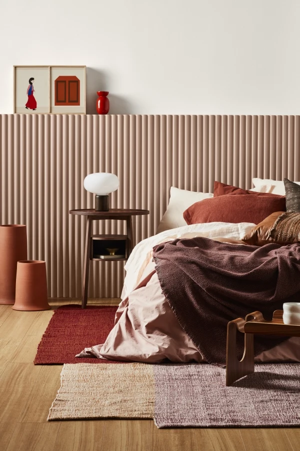 Warm bedroom featuring a fluted clay bedhead nib wall