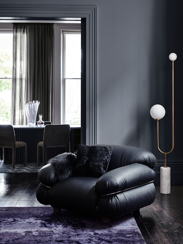 Black leather armchair in living room painted in deep grey Dulux Chainmail.