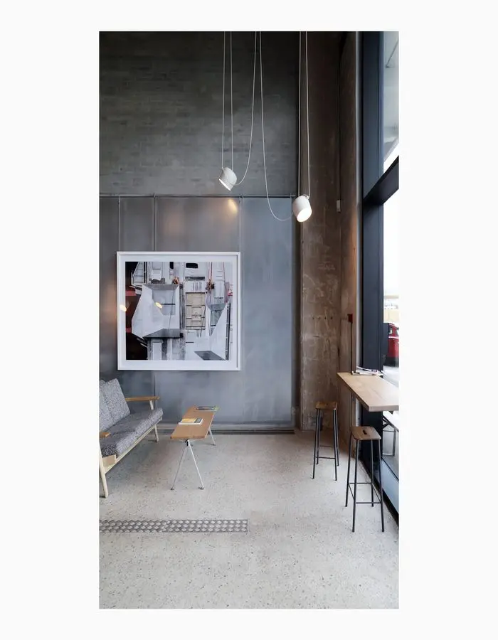 exterior grey office space with window seats and bench.