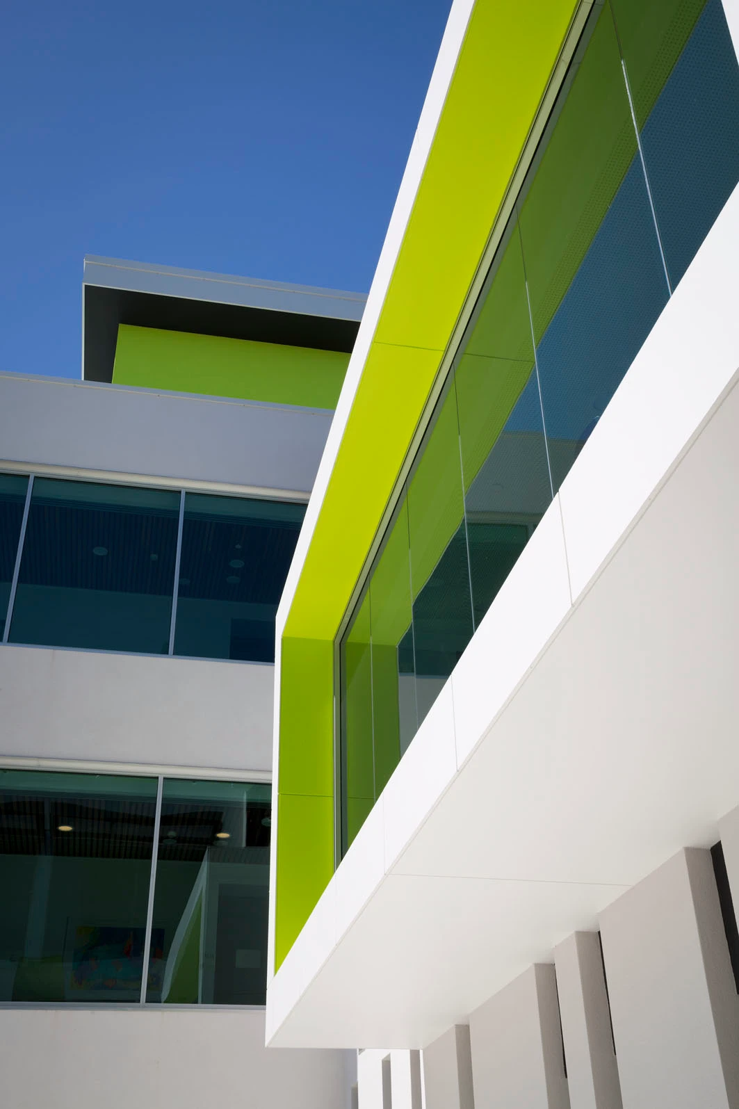 Green window trim on modern white medical building.