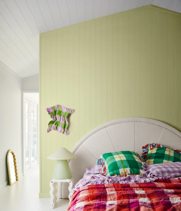 Dulux Celery Green featuring on panelled bedroom wall.