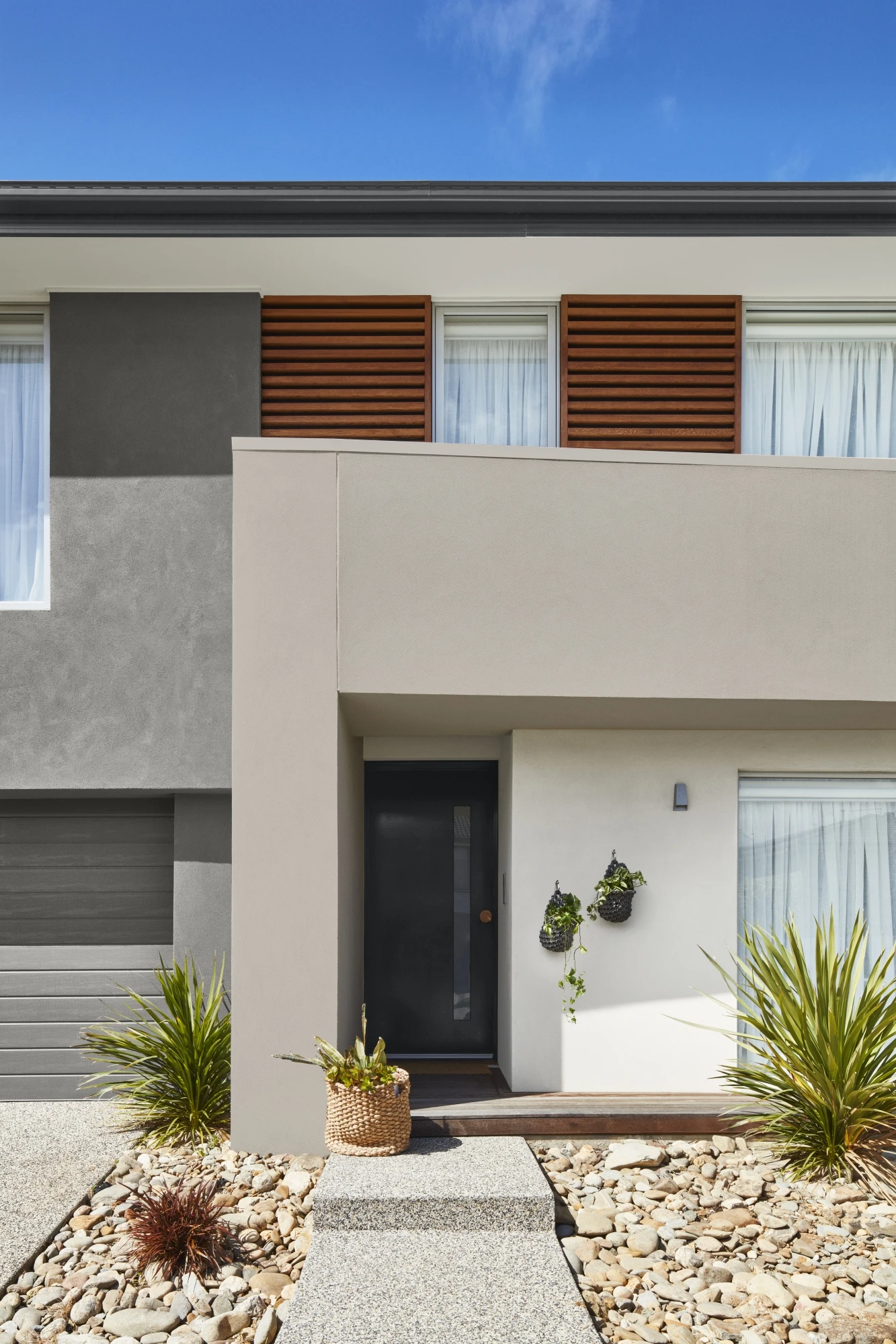 Exterior of a modern double-storey house in neutral shades 