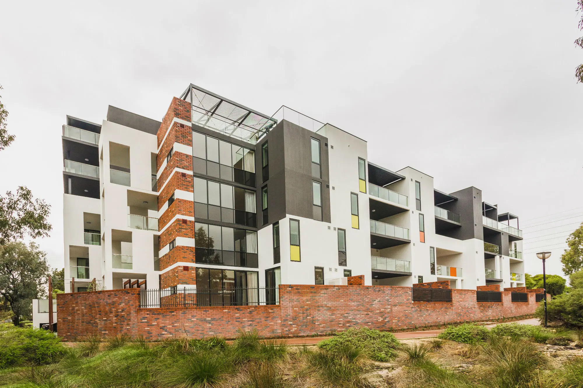 White render and red brick apartments.