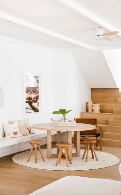 hinterland hideaway dining area in Dulux White on White with round wooden table and stools.
