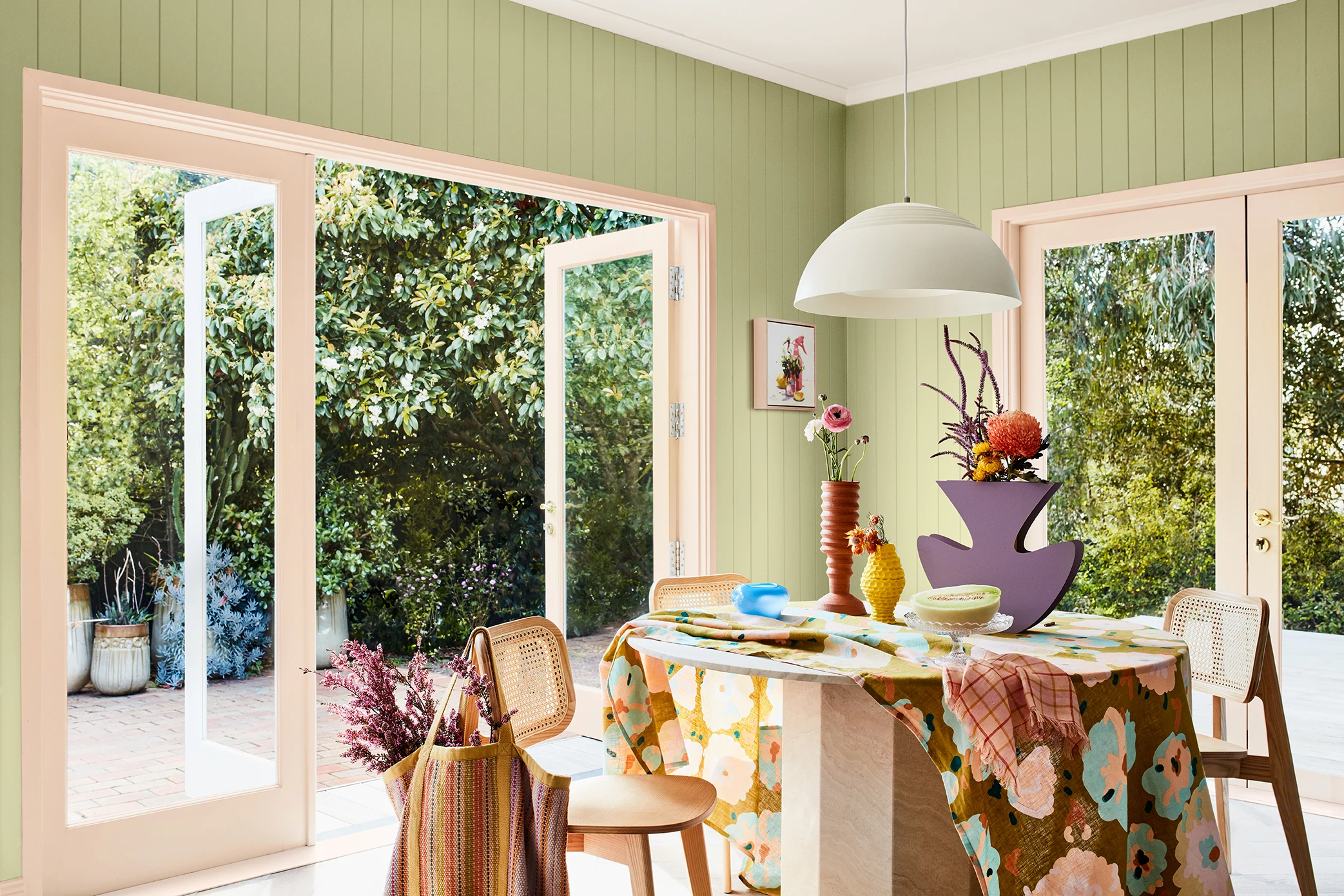 Dining room with Green VJ panelled walls, bifold doors and 2022 summer colour forecast palette.