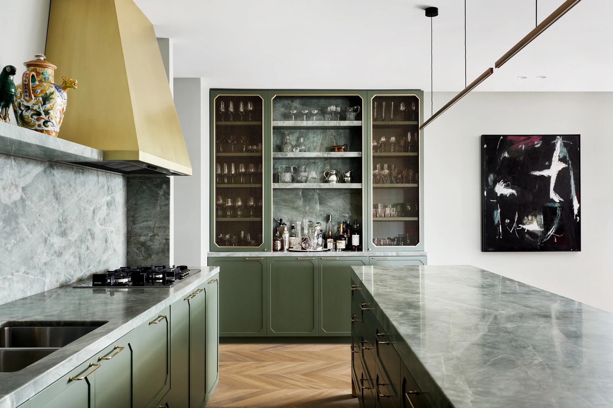 Green kitchen with marble benches