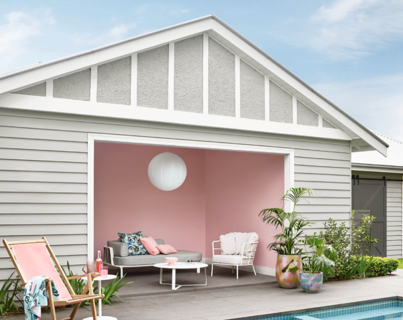 Neutral weatherboard pool house with pink interior.