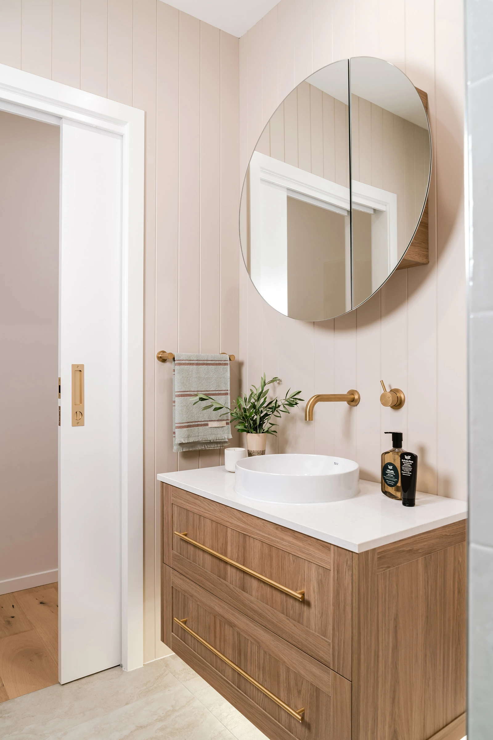 Neutral master ensuite with beige walls and timber vanity