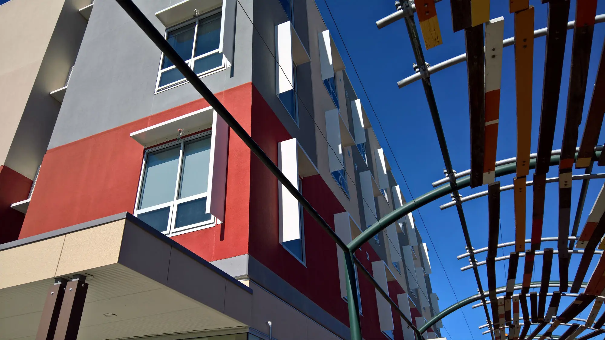 Apartment building in neutrals, red and grey