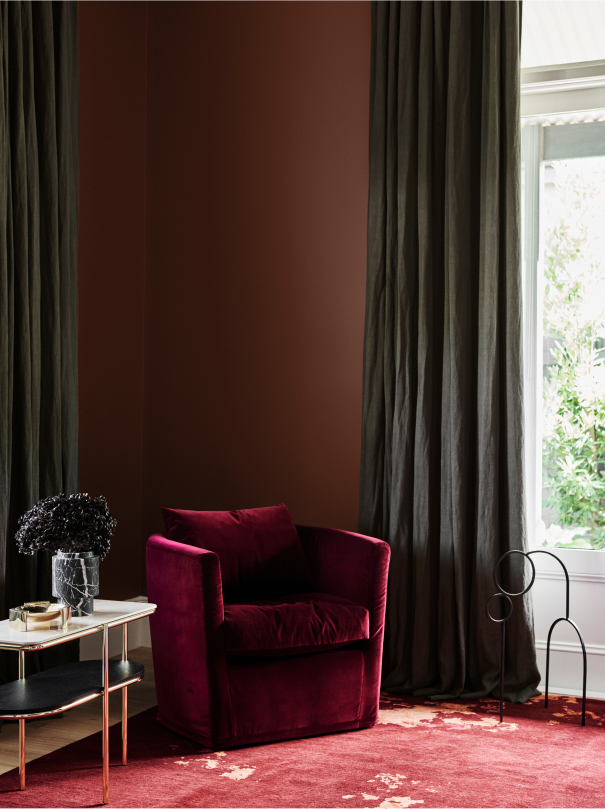 Brown study with maroon velvet tub chair