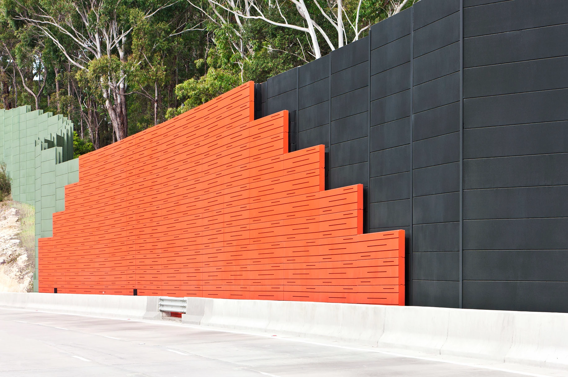 Orange and black exterior noise barrier wall.