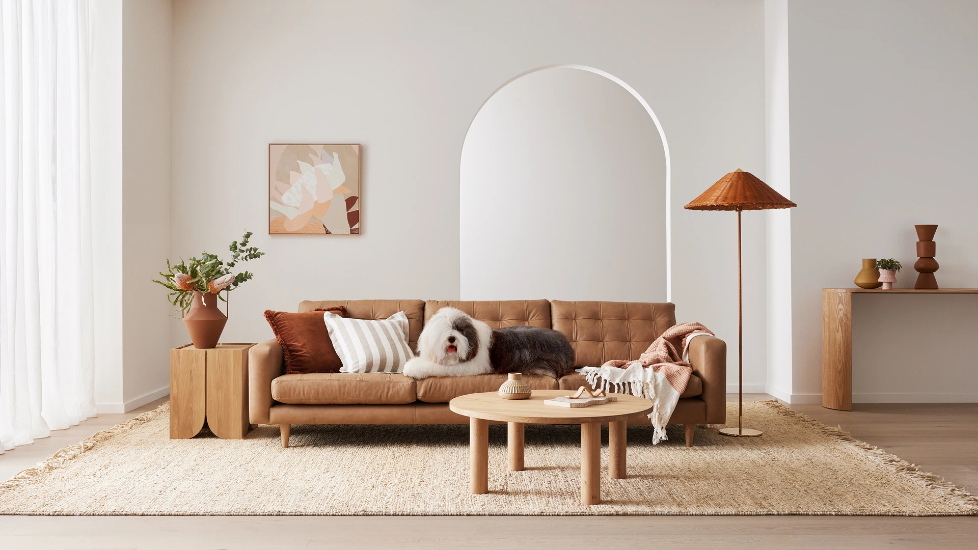 Living room featuring brown couch with Dog and Dulux Natural white paint on feature wall.