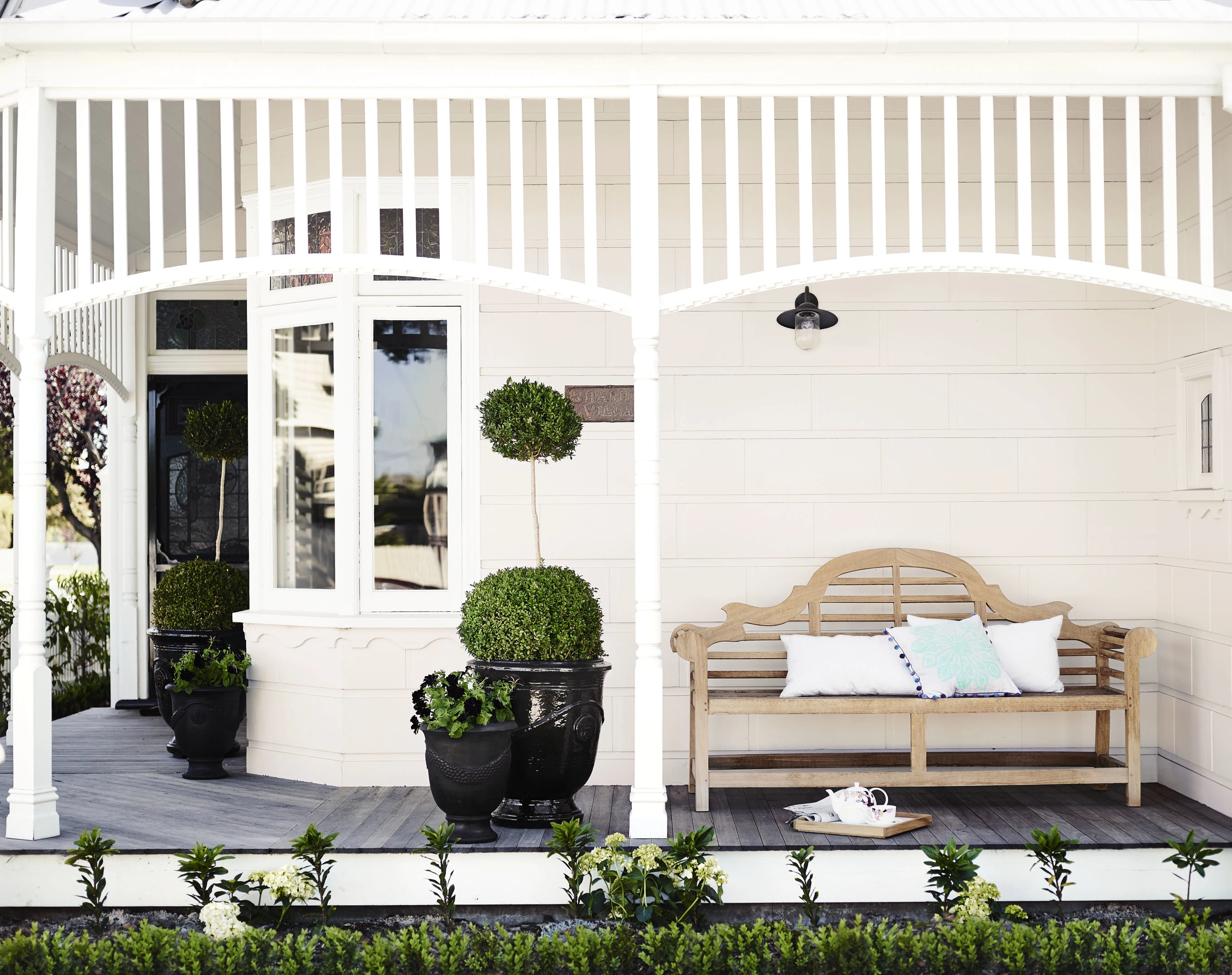 Cream house with white veranda posts and trim
