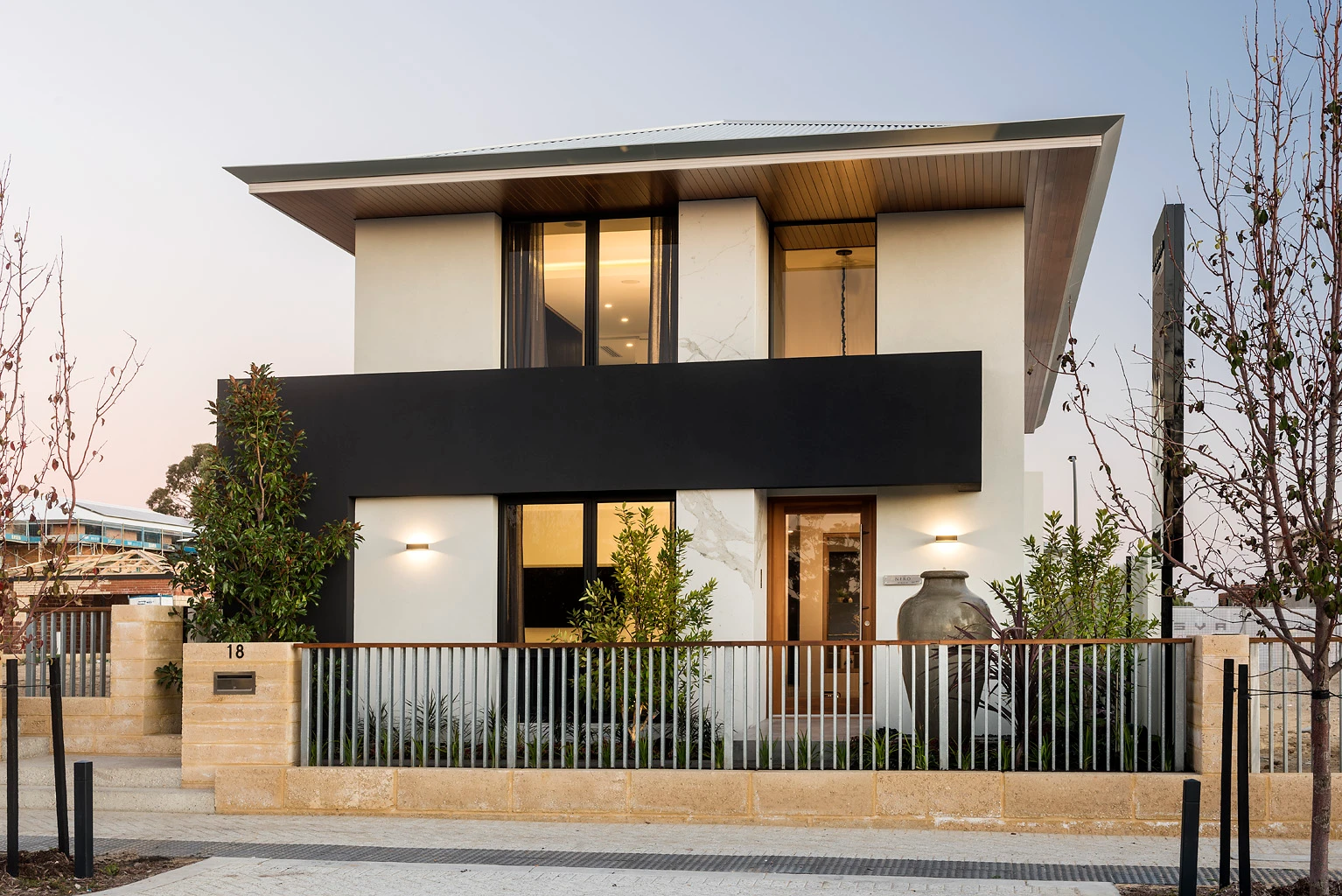 Double-storey house in neutrals with black balcony