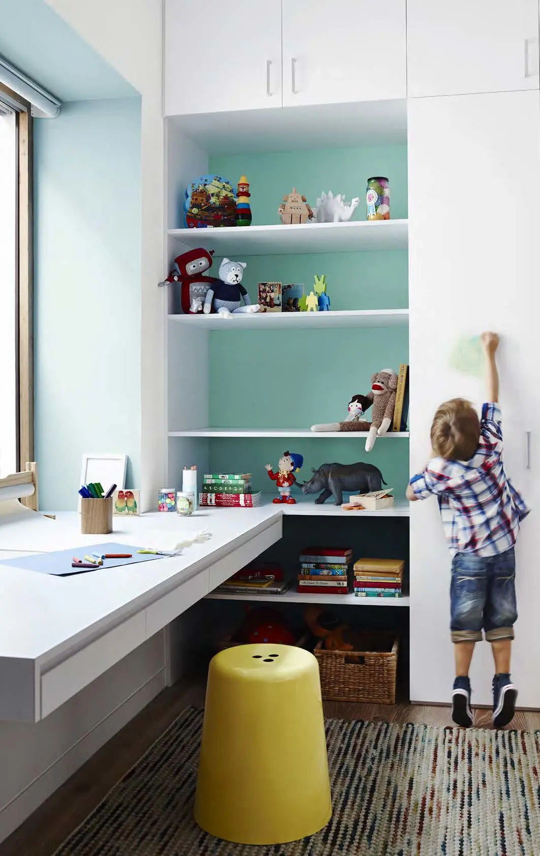 Children's play room with toys on bookshelf in Dulux Wash&Wear in Lexicon Quarter, Surf Watch, and Shimmer Quarter. Stylists: Bree Leech and Heather Nette King. Photographer: Lisa Cohen
