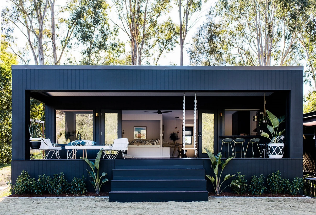 Black and dark charcoal home with bi-fold doors painted with black trims. 