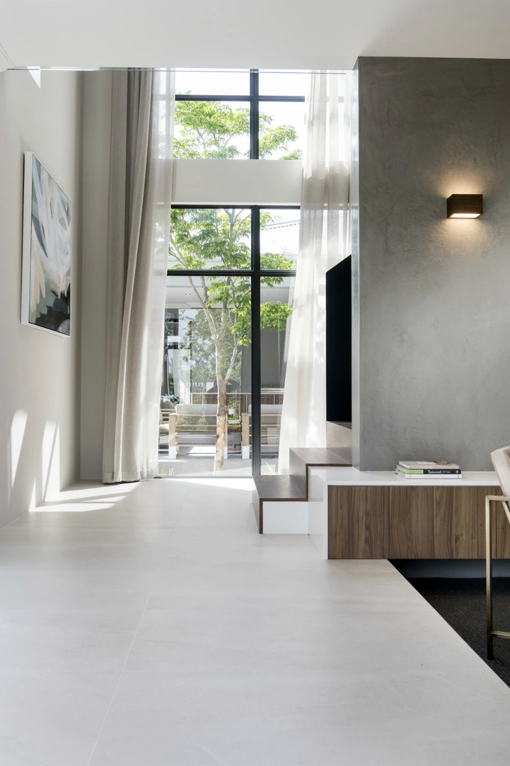 Neutral colours used in display home living area with long drapes..