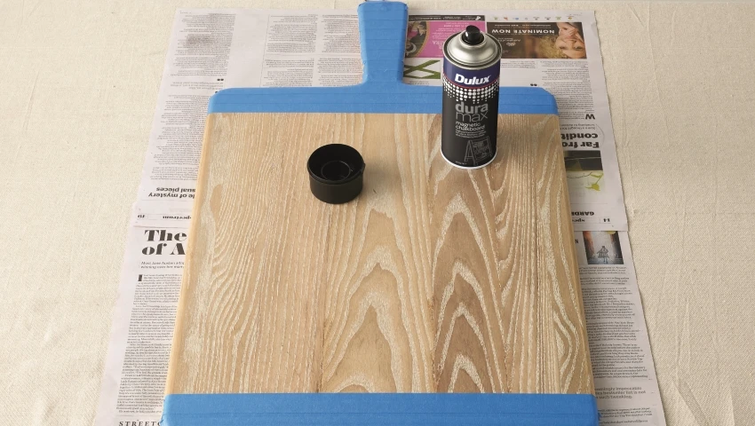 2. Tape areas of serving board that you do not want painted.