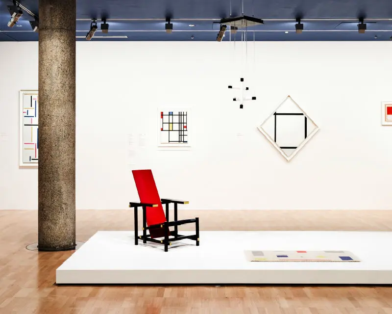 interior white gallery floor with red chair