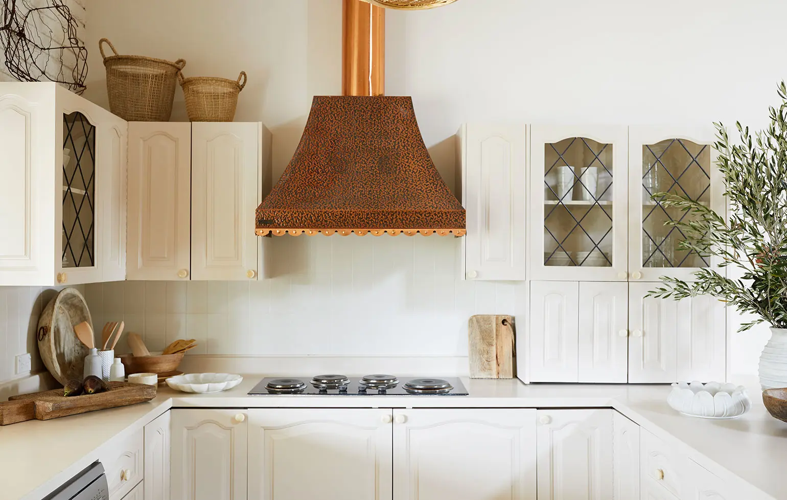 Rustic kitchen with large brass exhaust fan