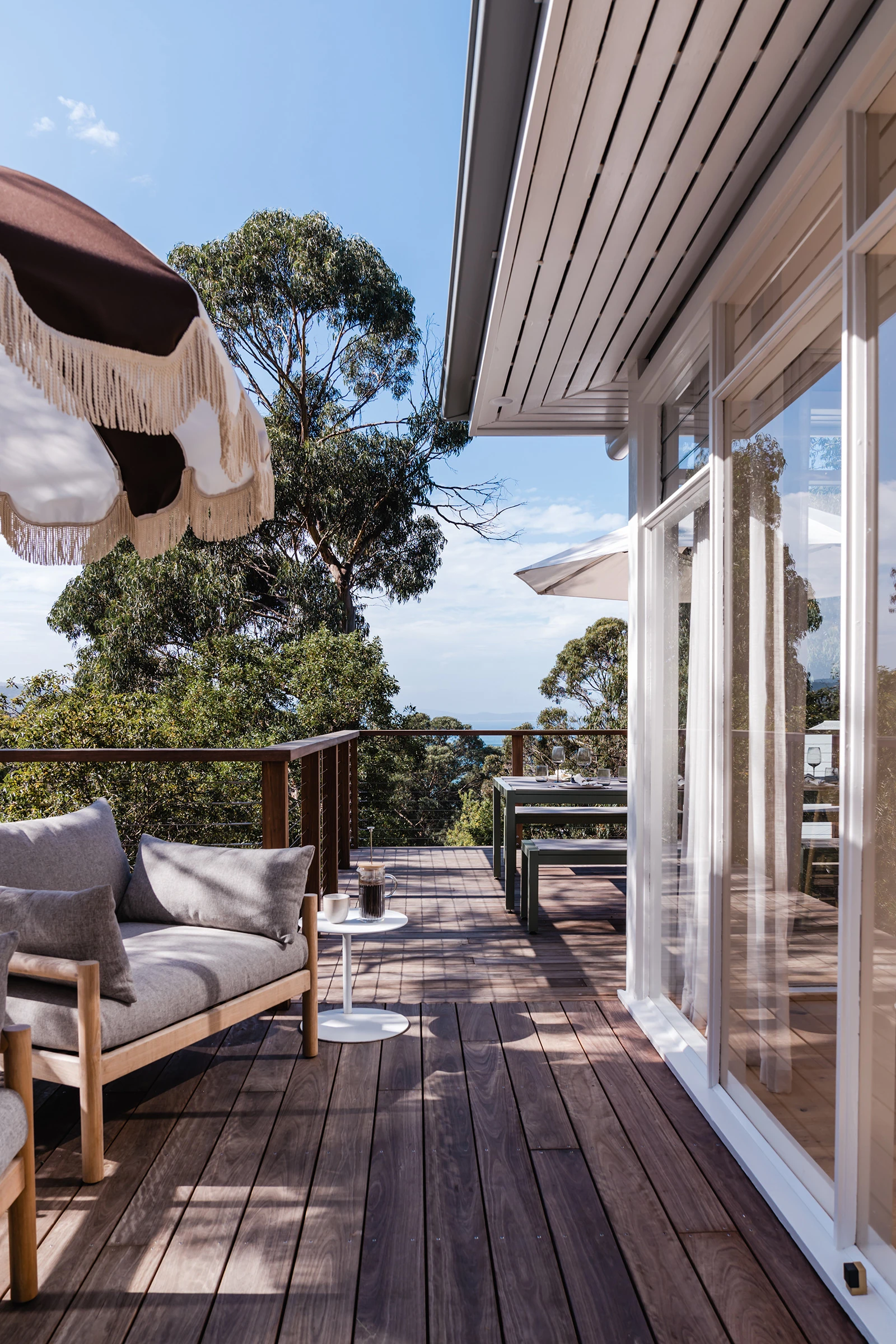 Beach house exterior deck with outdoor furniture