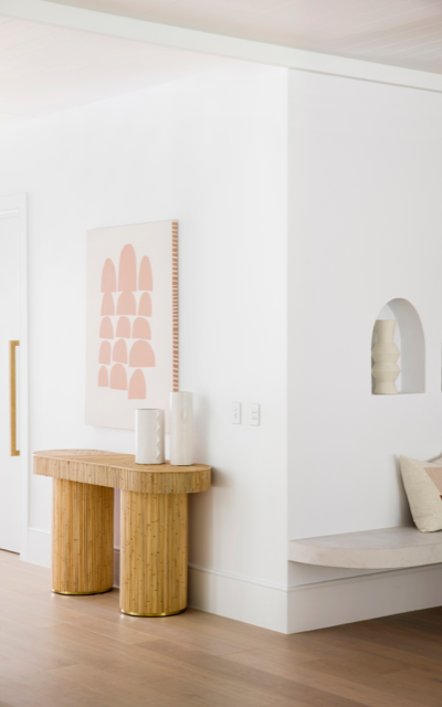 Hinterland Hideaway hallway in Dulux White-on-White with solid wooden hall table, artwork, bench seat with two white vases