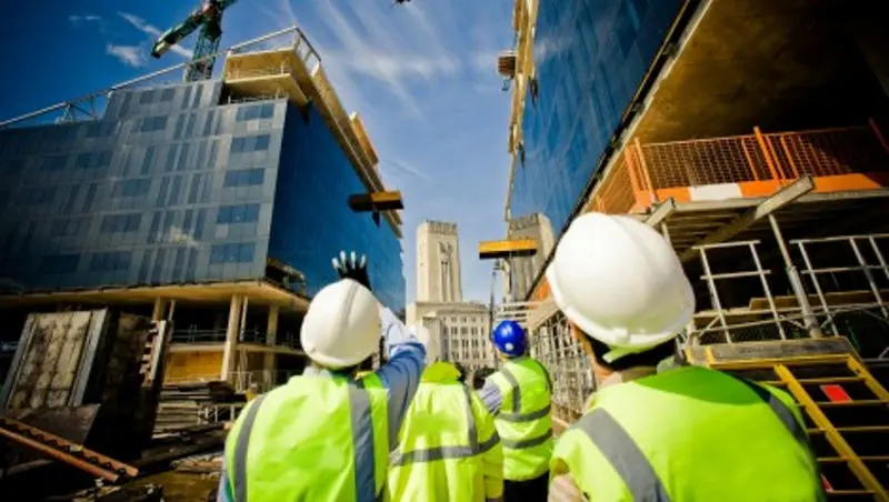 exterior building with construction workers. 