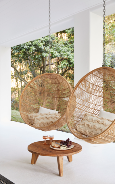 Hinterland Hideaway's two cane hanging chairs suspended from the verandah ceiling in Dulux White on White.