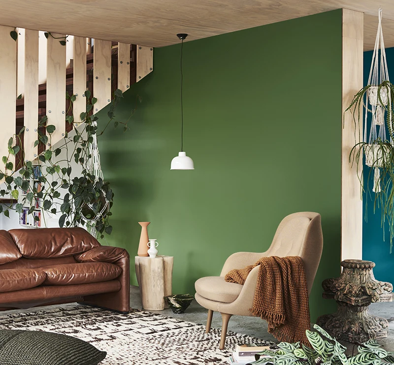 interior green lounge room with brown chair and couch. 