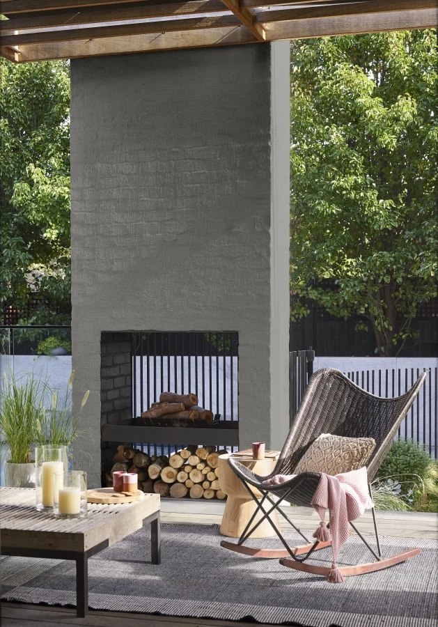 Exterior fireplace rendered with Dulux Texture Medium Cover behind a seating area