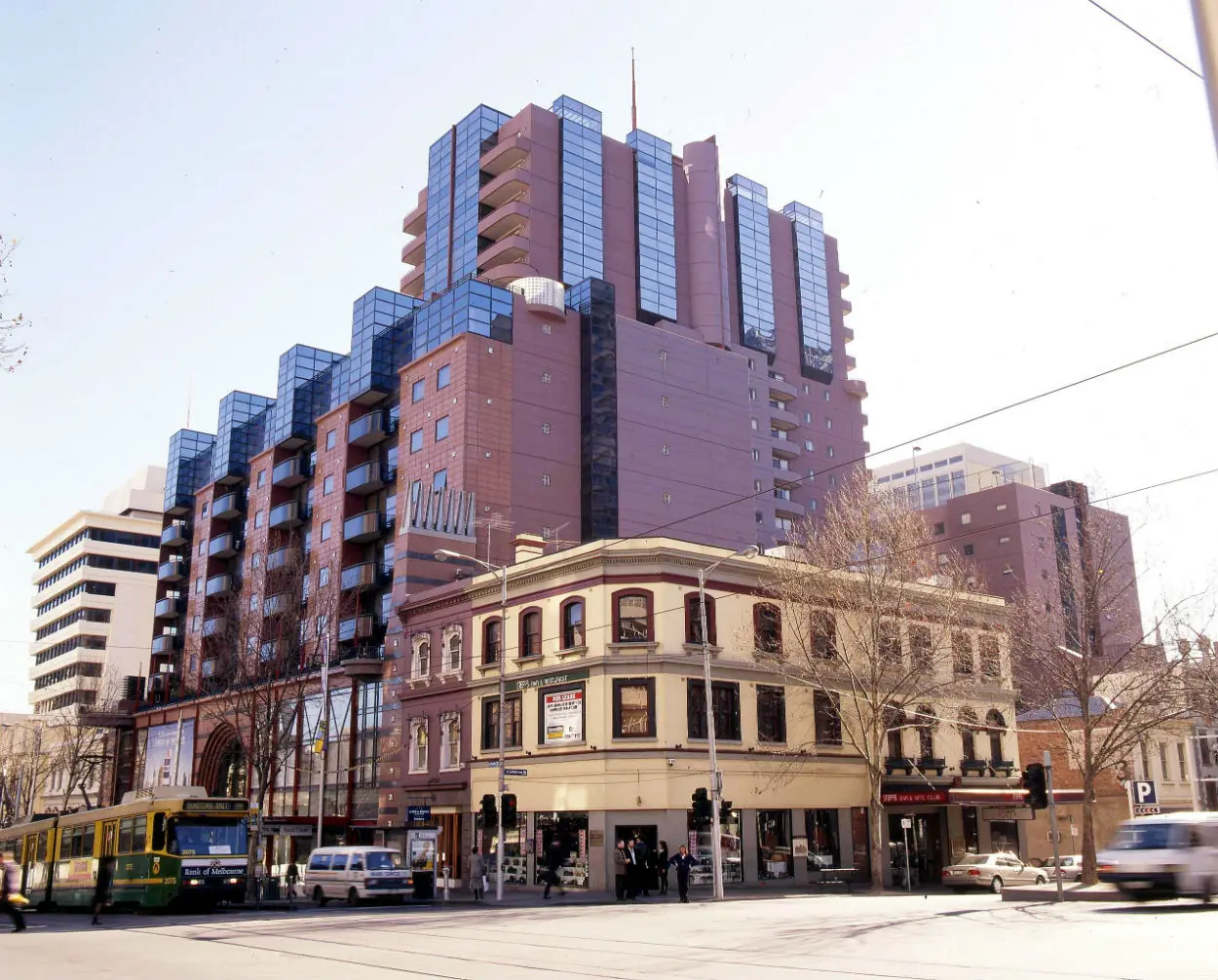 multistorey office building with old pub in foreground.