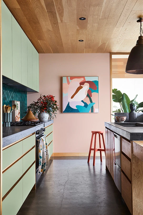 interior pink and green kitchen with painting.