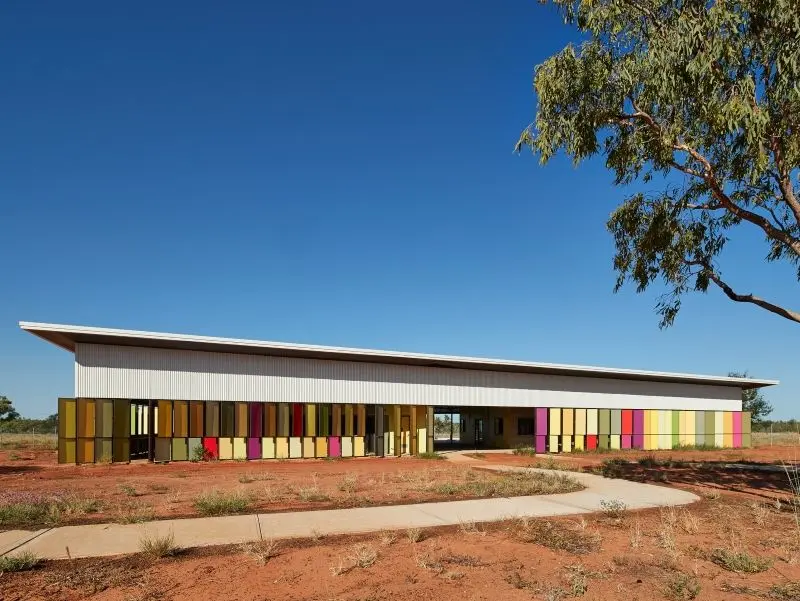 Outback building with sloping roof and multicoloured panels