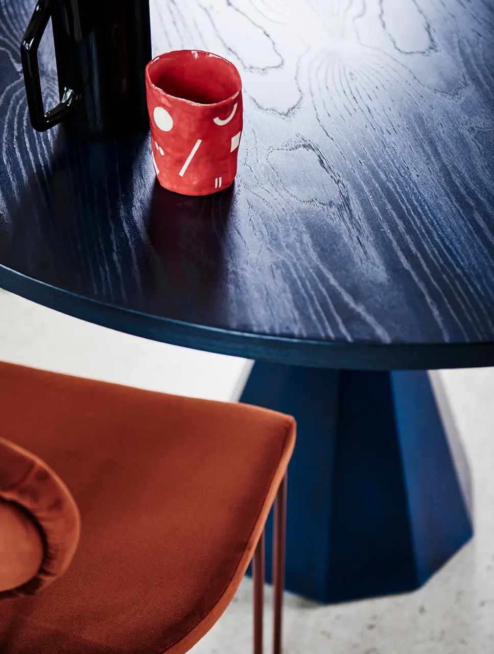 interior table with red mug and chair.