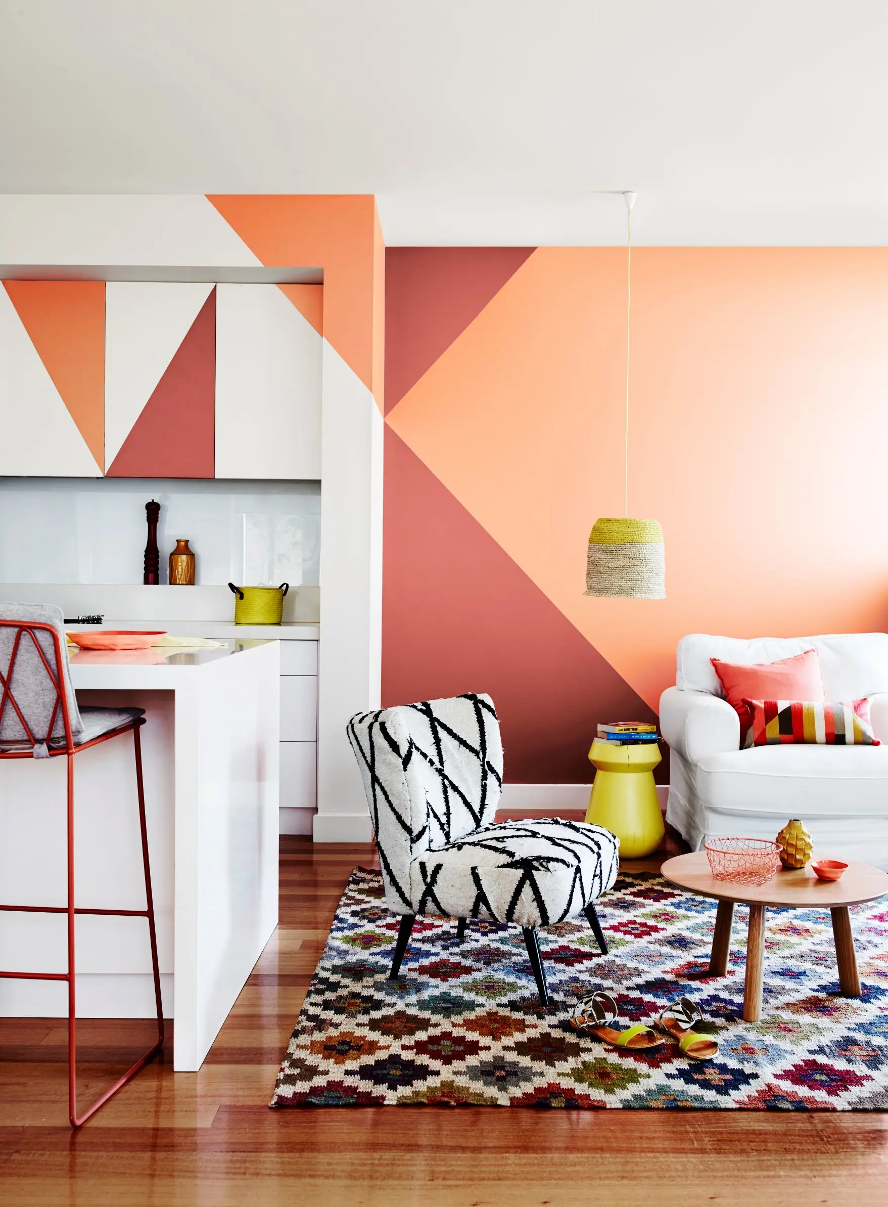 Red and orange interior feature wall with painted shapes