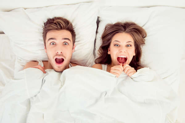 surprised couple in bed