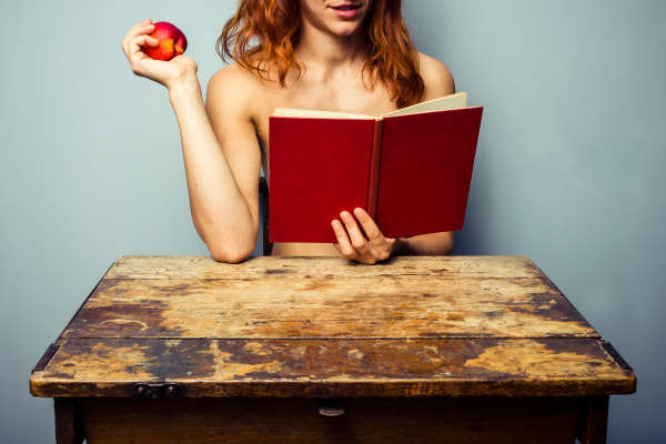 woman reading, holding peach