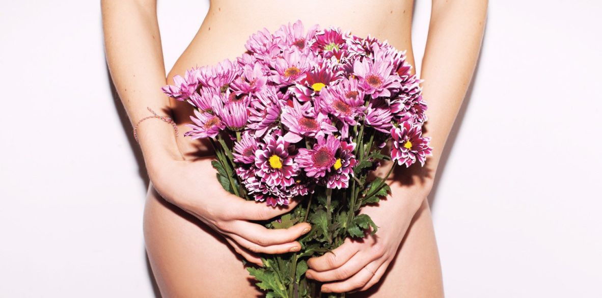 naked woman with flowers over her vagina
