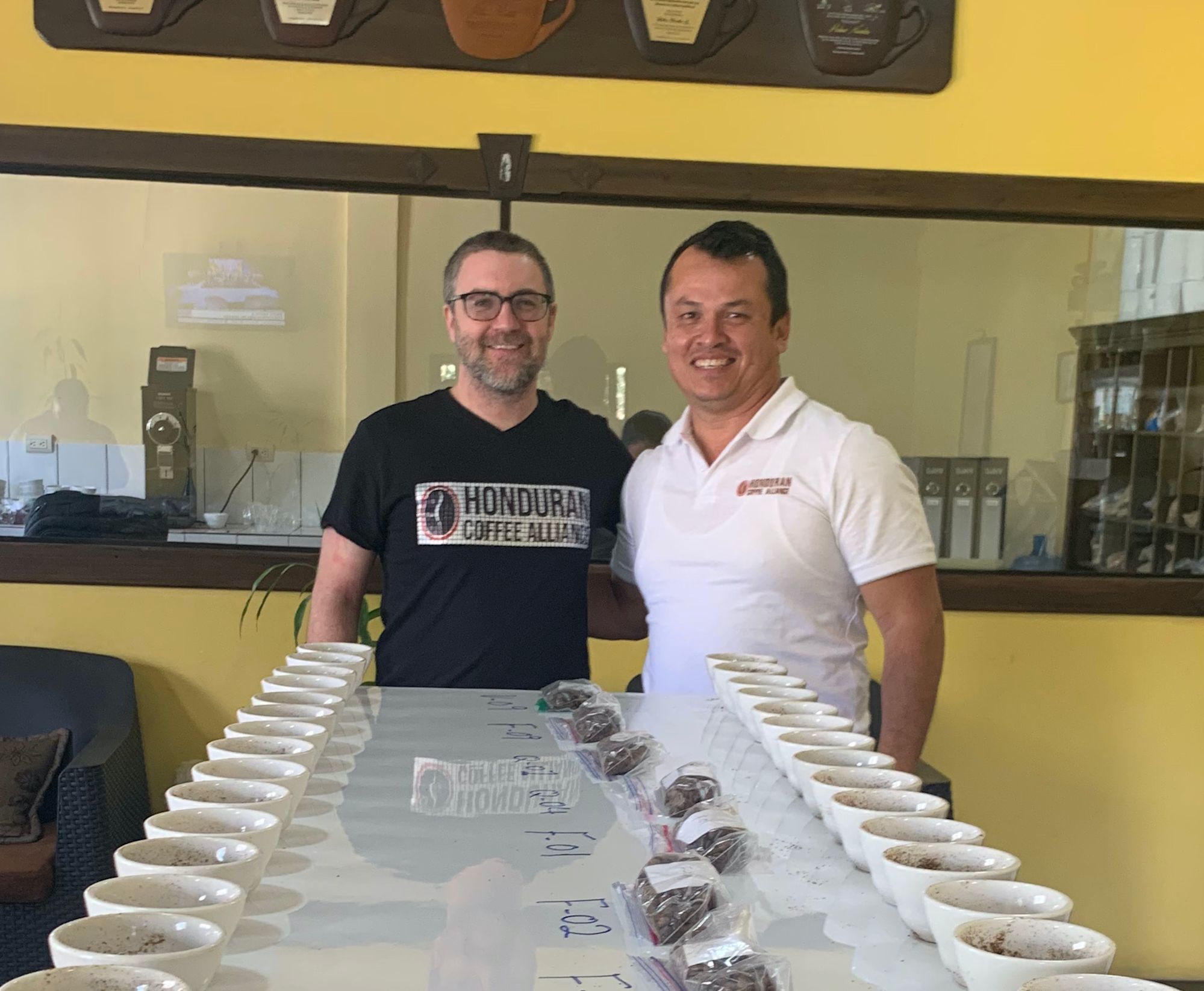 Sean and business partner Javier tasting and evaluating coffee