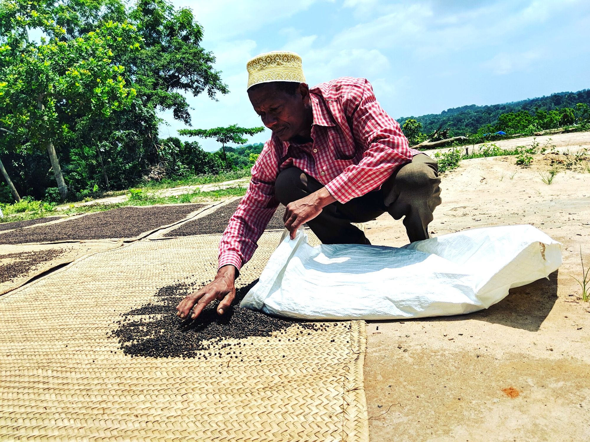 Burlap & Barrel farmer in Tanzania with black peppercorns