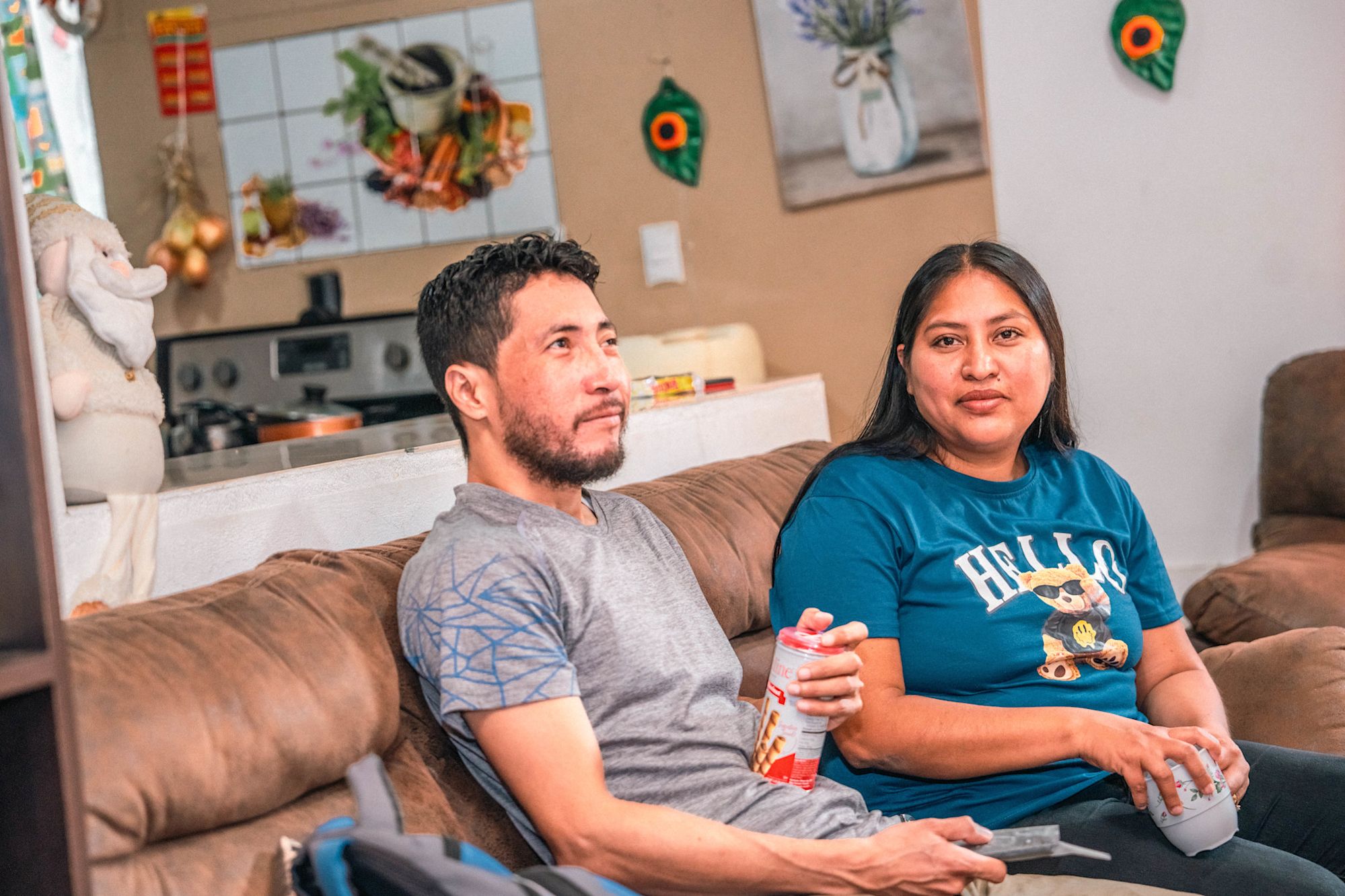 Lorena sits with her husband.