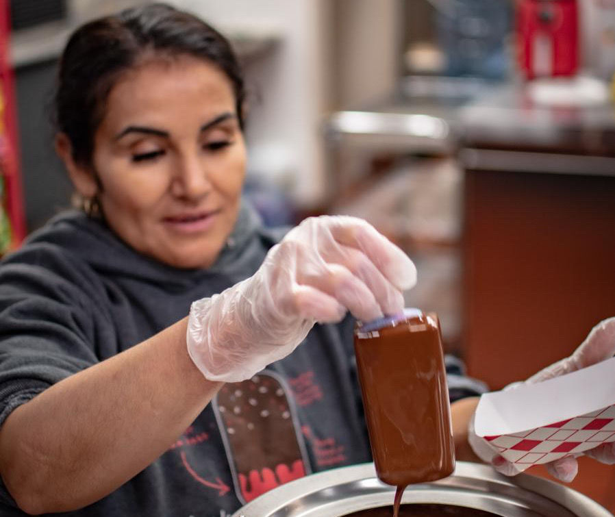 María Elena is the proud owner of Paleta Bar Mesa, a local shop that offers delicious artisanal popsicles.