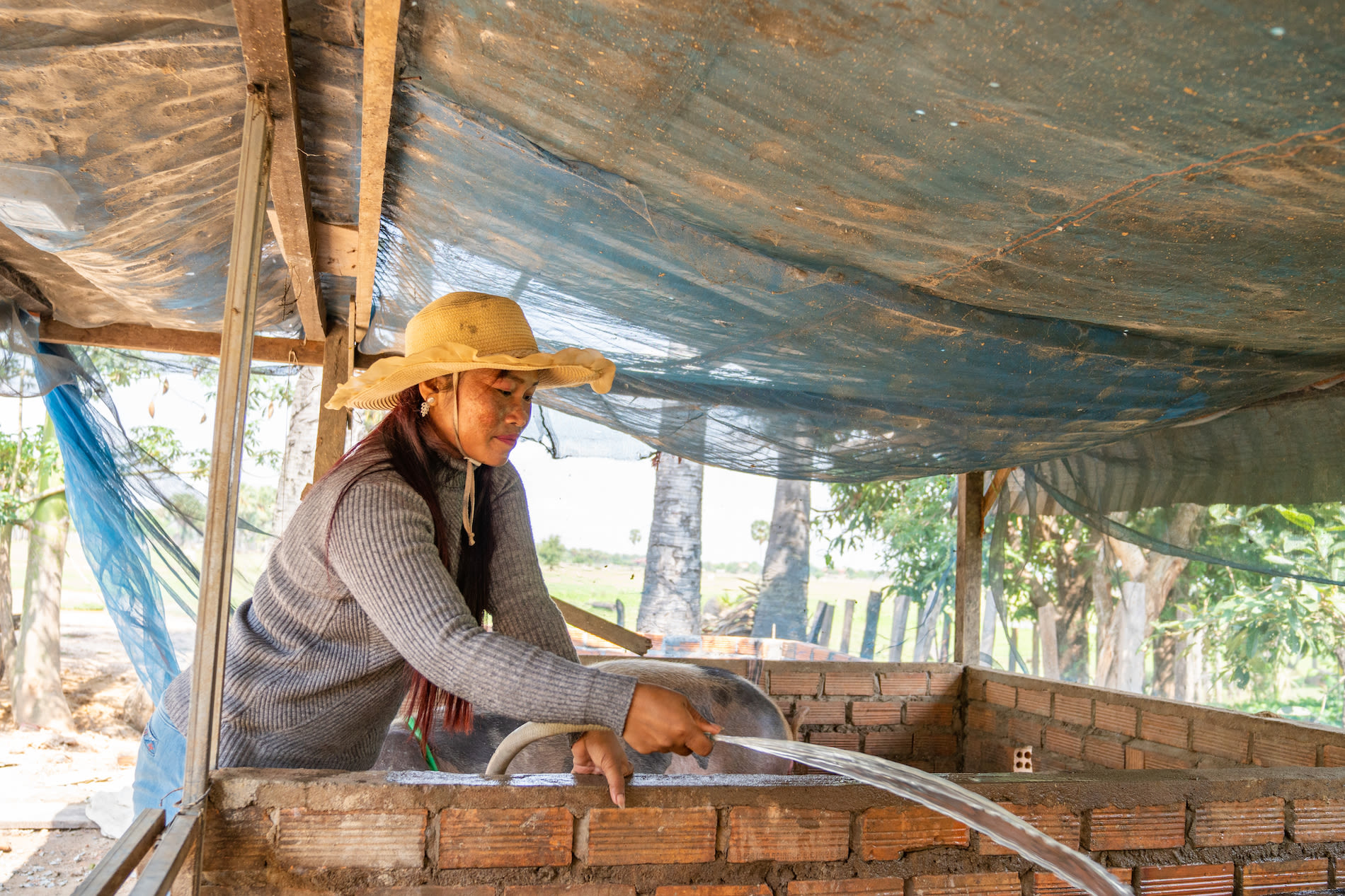 Raim is a pig farmer and wig maker in Cambodia who used her Kiva loan to purchase a clean cookstove for her family.