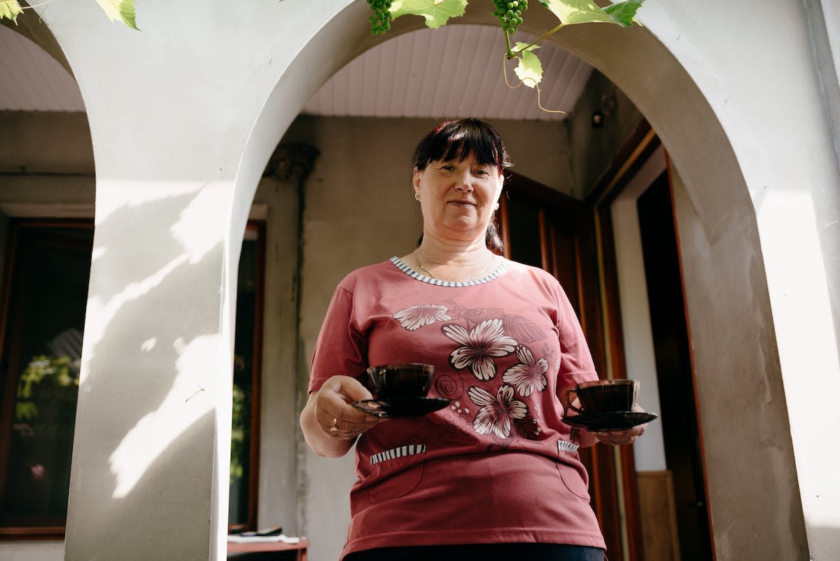 Tatiana in Moldova prepares coffee for the women who work on her farm.