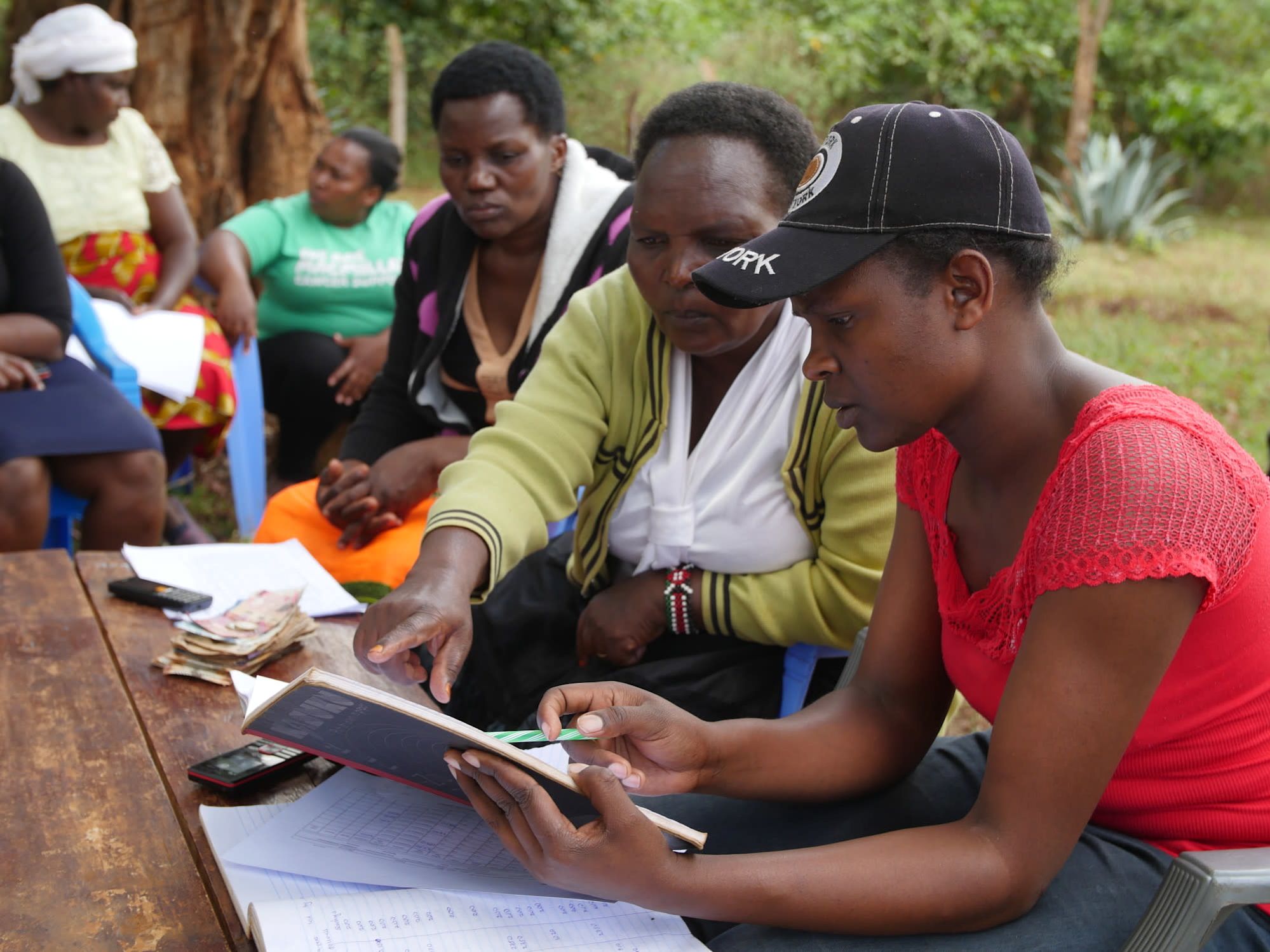 BORROWERS FROM ECLOF LOOK OVER LOAN PAPERWORK