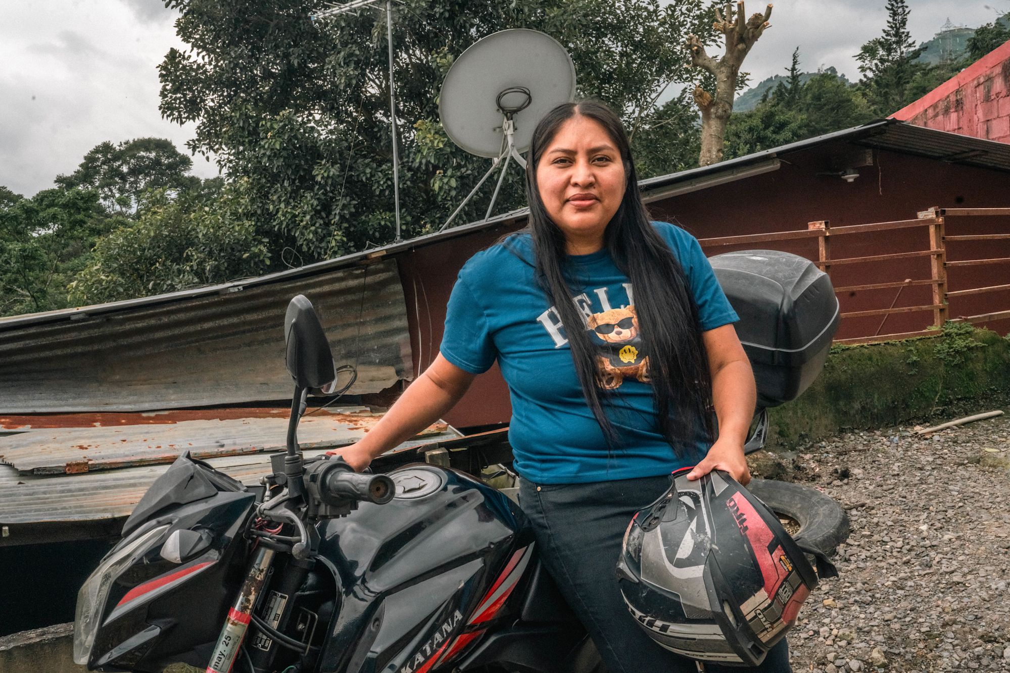 Lorena stands with her motorbike.