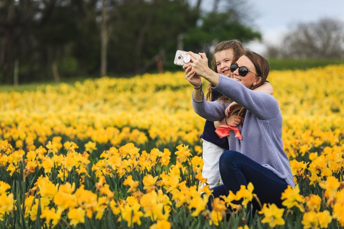 Mother and daughter in a field of tulips.